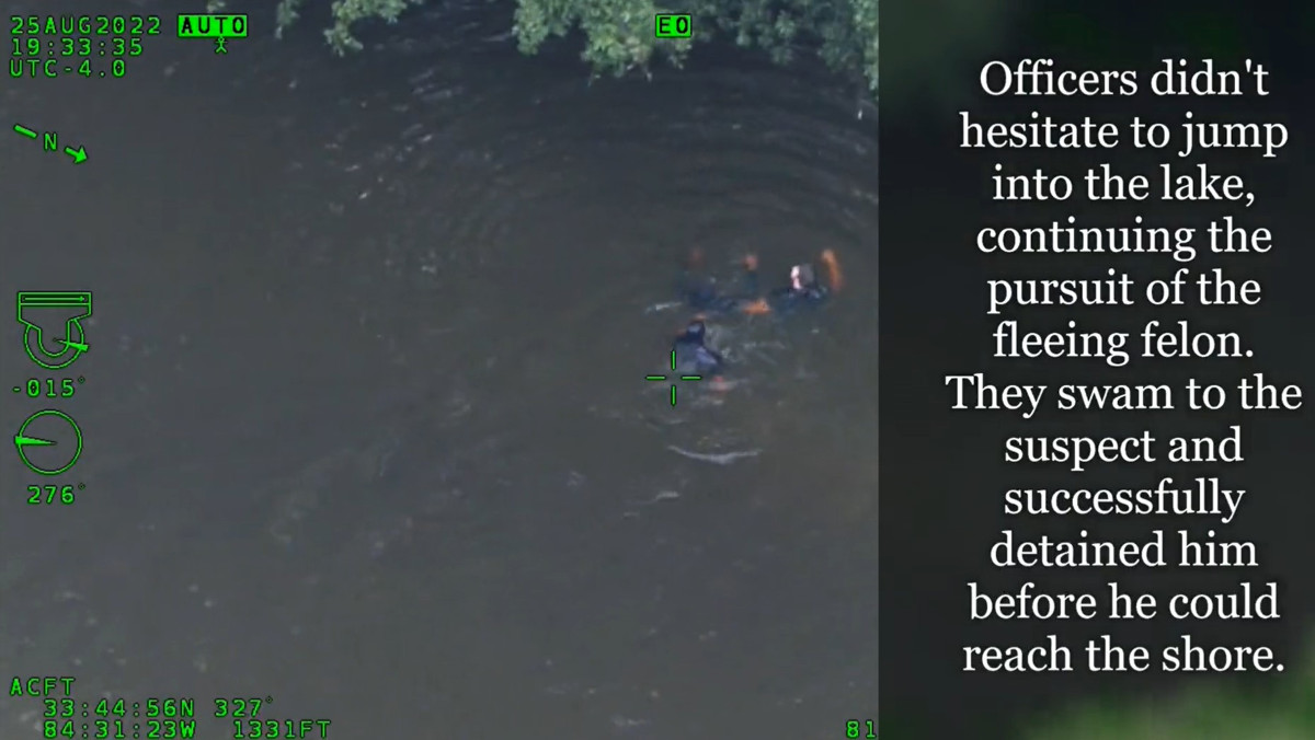 Two Atlanta police officers apprehend a suspect who tried to flee from arrest by swimming across a lake.