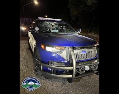 Two police officers were unharmed In Bellingham, WA, over the weekend after a man threw a 25-pound piece of wood into the windshield of their vehicle.