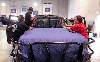 Technicians at one of Dana Safety Supply’s shops install a ballistic windshield into a law enforcement vehicle.