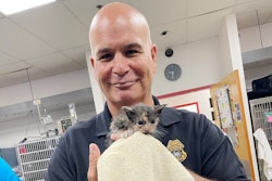 A Tampa police officer holds a kitten rescued by two officers Thursday during Hurricane Ian.