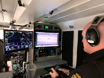 An Ohio State Highway Patrol tactical flight officer operates on of two vehicle speed measurement systems in use now.