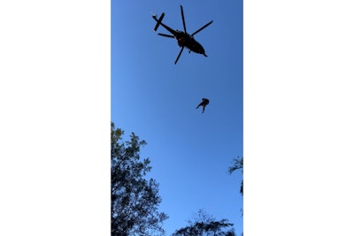 A Maryland State Police helicopter lowers a medic down to aid an injured hunter. (Photo: Maryland State Police)