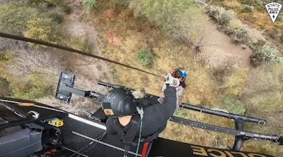 Member of a Boy Scout troop is hoisted into a New Mexico State Police helicopter. (Photo: NMSP/Twitter)