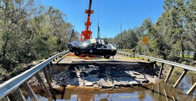 A Florida state trooper’s patrol car is hoisted from the water after being washed away with a trooper inside Sept. 29. The trooper was not injured.