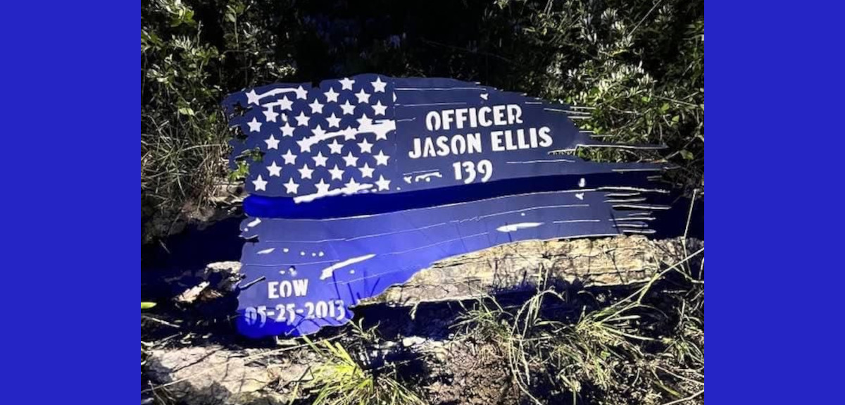 The Nelson County Sheriff’s Office is investigating the theft of this flag memorial dedicated to Jason Ellis, a Bardstown police officer who was fatally shot and killed in the line of duty in 2013.