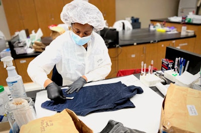 A GBI forensic biologist in the state crime lab examines evidence for biological fluids.