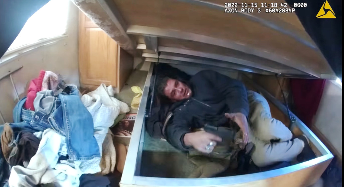 Body-worn cameras captured when a man hiding beneath a mattress ambushed officers searching inside a trailer earlier this month. One officer was wounded by shrapnel.