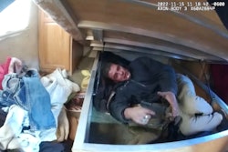 Body-worn cameras captured when a man hiding beneath a mattress ambushed officers searching inside a trailer earlier this month. One officer was wounded by shrapnel.