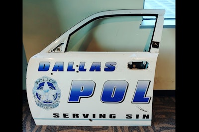 On display on the second floor is the door of a patrol car that was struck by gunfire during the 2015 attack on police headquarters by a man in an armored van.
