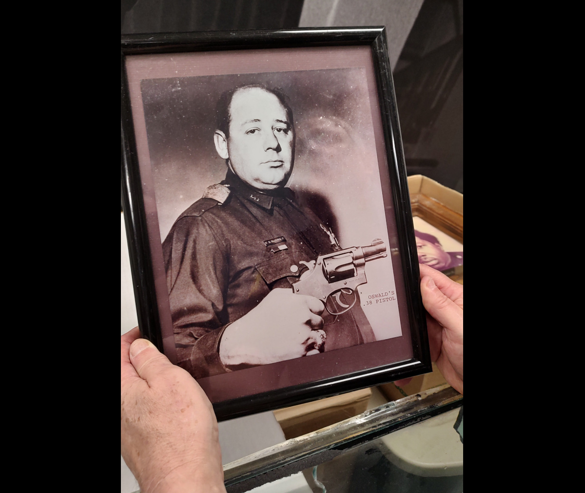 One framed photo shows an officer holding the revolver taken from Lee Harvey Oswald when he was arrested.