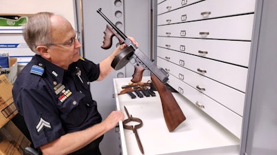 Senior Cpl. Paul Schuster shows the only Thompson submachine gun ever owned by the Dallas Police Department.[|CREDIT|] PHOTO: Wayne Parham