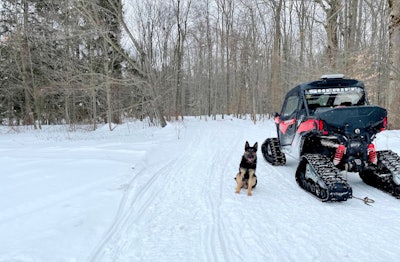 Artie, of the Erie County Sheriff’s Office, is shown beside a UTV that has been equipped with tracks for better travel in snow.