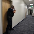 An officer with the Colorado School of Mines Police Department is seen wearing an Augmented Reality (AR) headset while engaged in a training simulation.