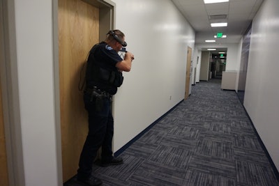 An officer with the Colorado School of Mines Police Department is seen wearing an Augmented Reality (AR) headset while engaged in a training simulation.