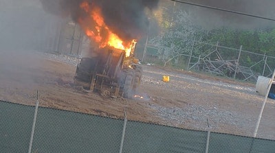 Construction equipment burns after an attack at the Atlanta Public Safety Training Facility Sunday.