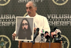 Volusia County, FL, Sheriff Mike Chitwood holds a photo of a New Jersey man who is being extradited to Florida over death threats against him.