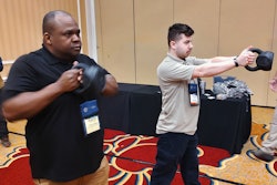 Cpl. Torre Jennings, left, of the Cherokee County Sheriff's Office (GA), and Officer Vitaliy Moskvich, of the Hamilton Police Department (NY), practice with kettlebells to learn how to improve their shooting muscles.