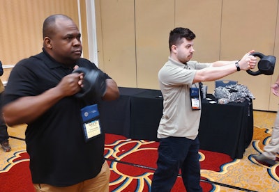 Cpl. Torre Jennings, left, of the Cherokee County Sheriff's Office (GA), and Officer Vitaliy Moskvich, of the Hamilton Police Department (NY), practice with kettlebells to learn how to improve their shooting muscles.