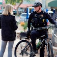 An officer speaks with a member of the community while on bike patrol. Community engagement is a large part of what bike officers do.