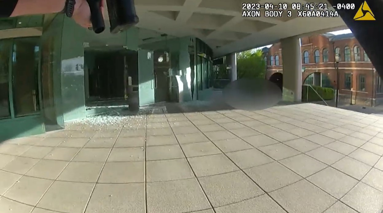 Patrol rifle at the ready, Officer Cory C.J. Galloway approaches the lobby of the Old National Bank and the downed gunman inside. Officer Galloway shot and killed the suspect.