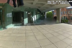 Patrol rifle at the ready, Officer Cory C.J. Galloway approaches the lobby of the Old National Bank and the downed gunman inside. Officer Galloway shot and killed the suspect.