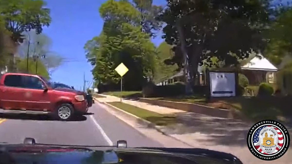 Police dashcam video shows a suspect losing control and crossing into the path of a Lawrenceville, GA, police vehicle just before the collision.