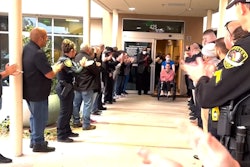 Officer Lina Mino is greeted by officers from several departments during her discharge from treatment in December.
