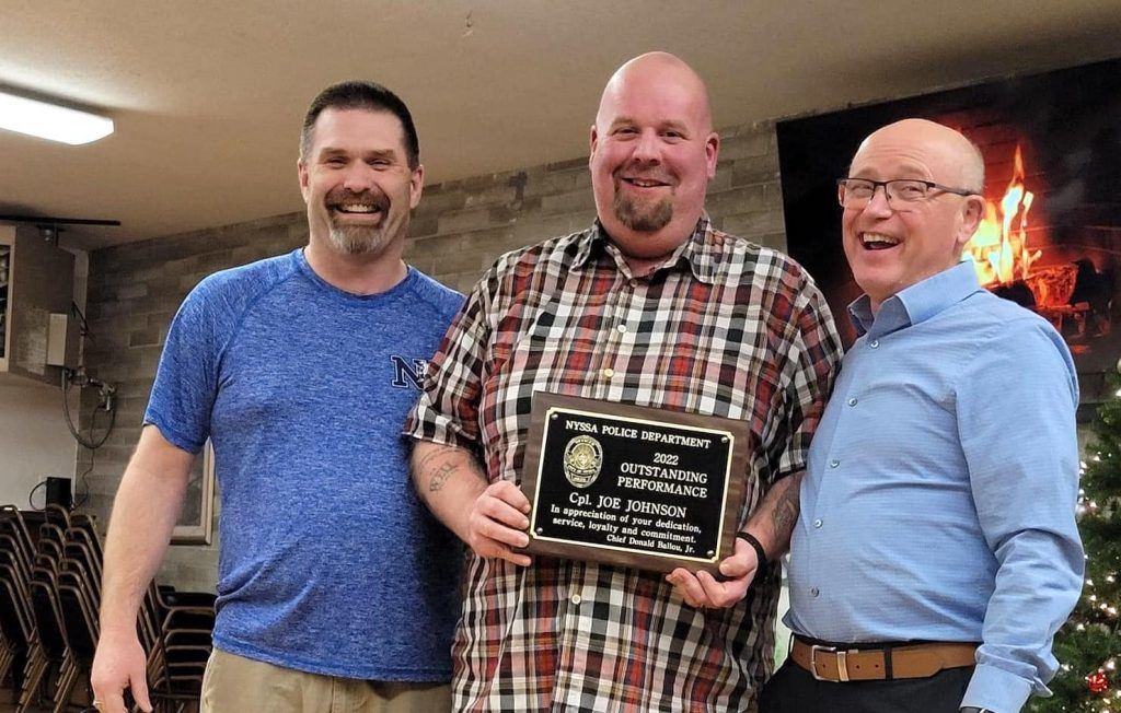 Joseph Johnson, center, receives the Outstanding Performance Award from the Nyssa Police Department, where he was a reserve officer. It was presented by Chief Don Ballou and City Manager Jim Maret.