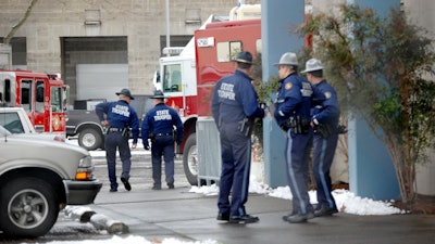 Oregon state troopers are shown in their waist-length rain gear.