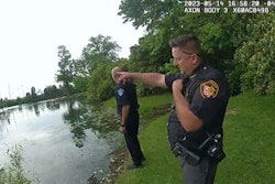 Blue Ash, OH, police officers prepare to enter a pond to rescue a six-year-old autistic girl.