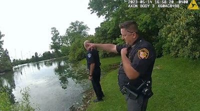 Blue Ash, OH, police officers prepare to enter a pond to rescue a six-year-old autistic girl.