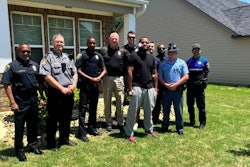 Officer Rashad Rivers (gray pants) outside his home with fellow officers after being released from hospital.