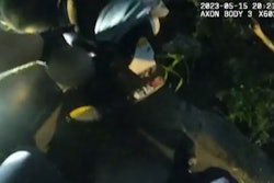 A Fort Worth officer picks up an infant who was kidnapped Monday during a vehicle theft and abandoned in a nearby ravine