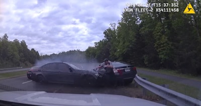 A Fairfax County, VA, police officer reacts as an out-of-control car crosses the highway and strikes the vehicle he has stopped. He was struck but only sustained minor injuries.