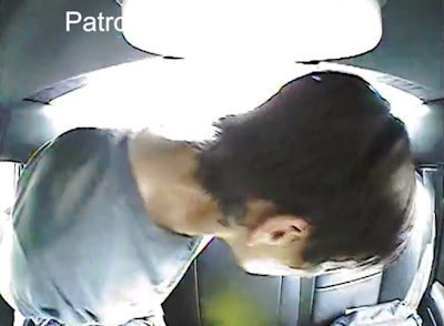 The suspect moves around in the back seat of a trooper's car while slipping his cuffs beneath his feet to bring his hands to the front before stealing the car.