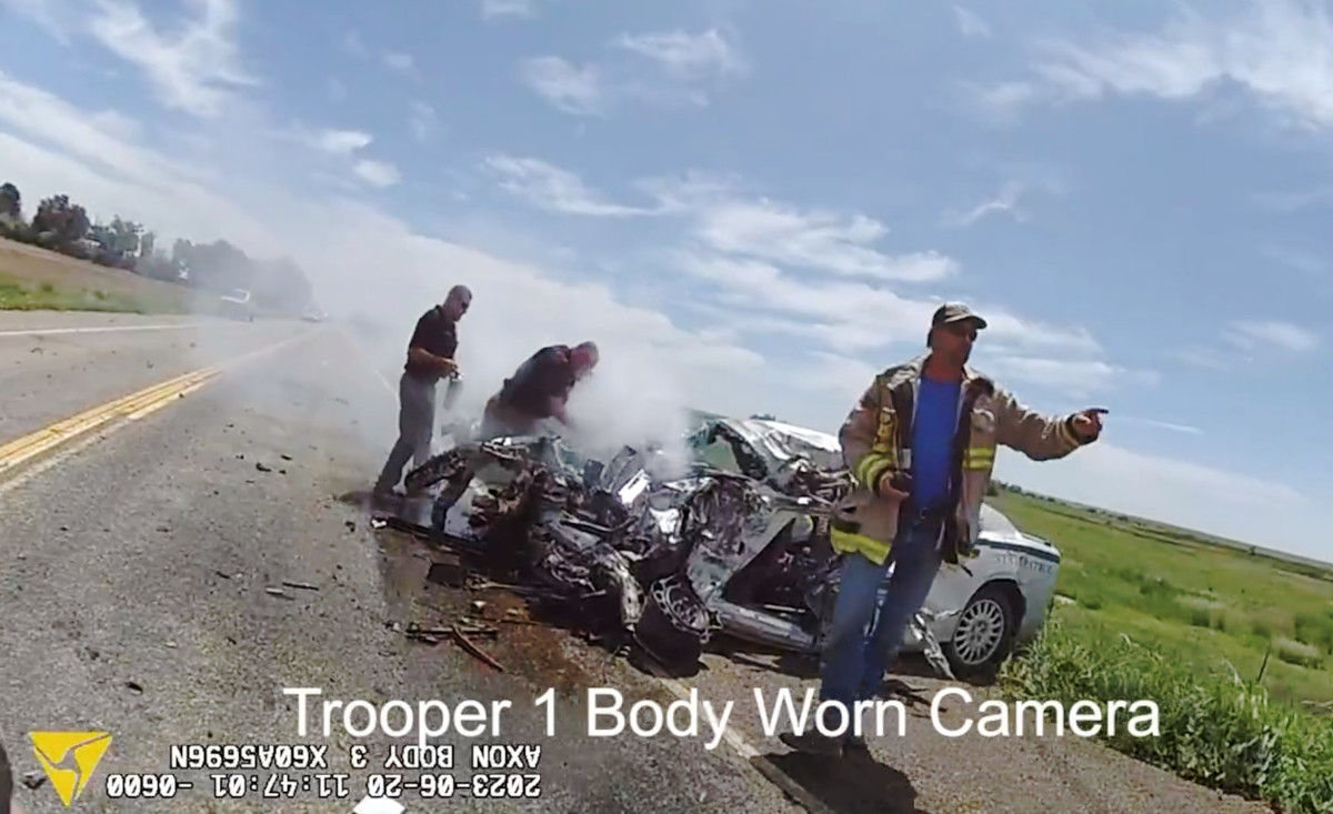 Extinguishers are used to control a car fire after a suspect stole this Colorado State Patrol vehicle, fled from troopers, and then crashed into a tractor-trailer.