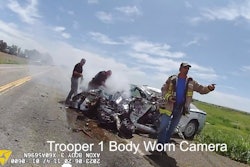 Extinguishers are used to control a car fire after a suspect stole this Colorado State Patrol vehicle, fled from troopers, and then crashed into a tractor-trailer.