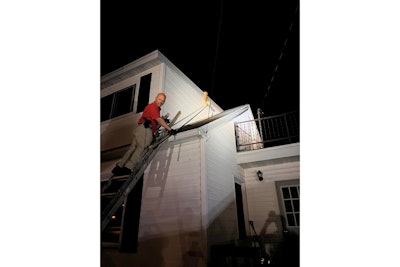Capt. Jason Hagen went up a ladder and used a pole to bring the snake off of the roof.