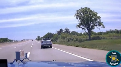 Still image from Michigan State Police video showing trooper pursuing 10-year-old driving SUV.