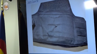 Back panel of Denver officer's vest showing bullet damage from ambush.
