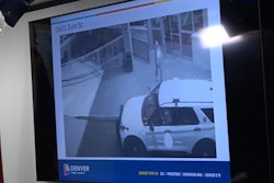 Surveillance camera video grab showing suspect firing on Denver officer outside of hotel. The officer was ambushed in his patrol vehicle.