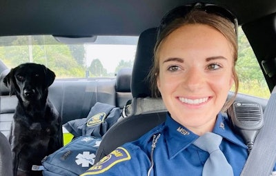 Trooper Kayla Moore, of the Michigan State Police takes a selfie with Rosie, the dog she rescued and adopted, in the backseat.