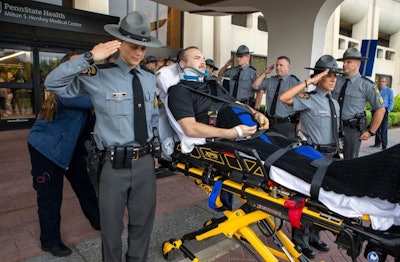 Fellow Pennsylvania State troopers salute Lt. James Wagner as he is discharged from the Penn State Health Milton S. Hershey Medical Center Monday.