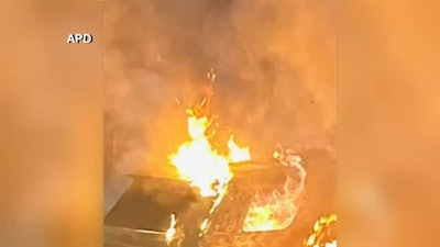 Two Asheville, NC, police vehicles burn early Monday after an arson attack.