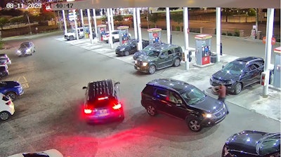 Chattanooga Police Officer Celtain Batterson approaches the suspect's SUV. Batterson was shot in the arm during the incident.