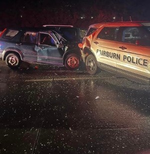 A Fairburn, GA, police officer was injured Wednesday when his vehicle was struck at an accident scene on I-85.