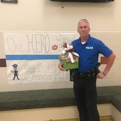Officer Bryan Holley on duty in a Hudson, TX, school. He died Friday after a medical crisis on duty.