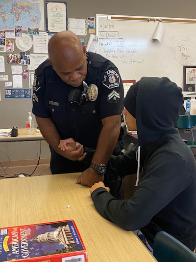 A Los Angeles School Police officer counsels a student.