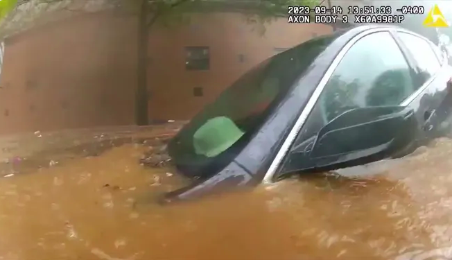 Vehicle submerged in downtown Atlanta flood waters. The occupant was rescued by an officer and a firefighter.