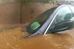 Vehicle submerged in downtown Atlanta flood waters. The occupant was rescued by an officer and a firefighter.